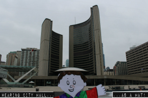 Wearing City Hall as a Hat, PLAY TOURIST IN YOUR OWN CITY, from the 10 Best Ways to Entertain Flat Stanley